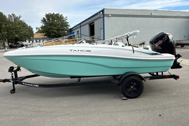 Slide: The Image of 2027 Tahoe T18 boat on trailer, mint green hull, parked outdoors. - 1