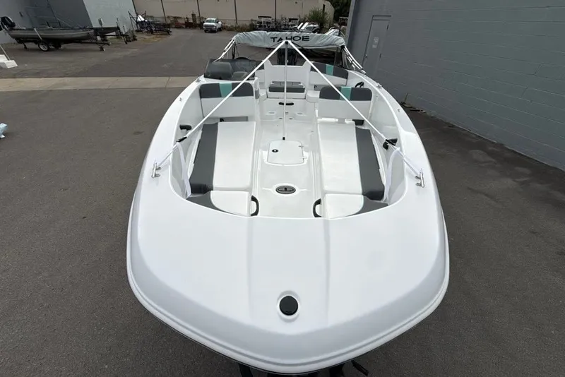 Slide: The Image of 2027 Tahoe T18 boat with sleek white design, parked outdoors. - 7