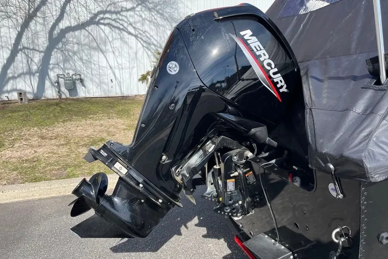 Slide: The Image of 2023 Lund 1650 Rebel XL Sport with Mercury outboard motor, parked outdoors. - 7
