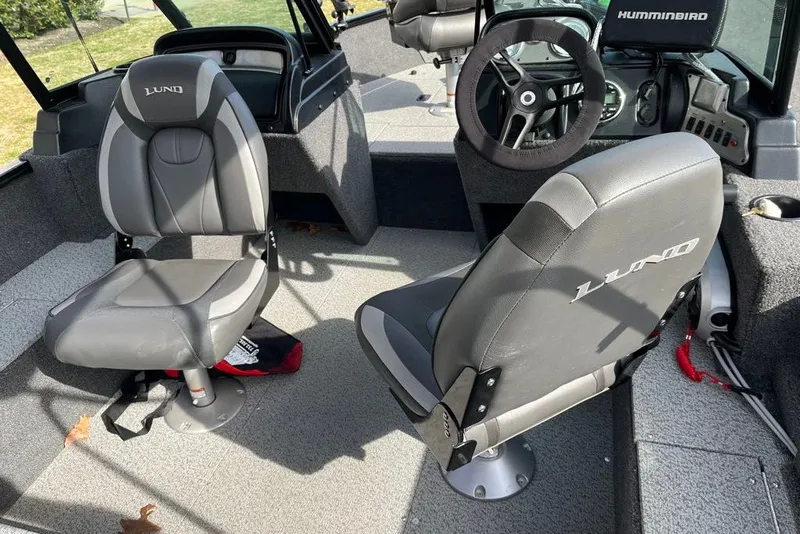 Slide: The Image of 2023 Lund 1650 Rebel XL Sport boat interior with seating and steering wheel. - 5