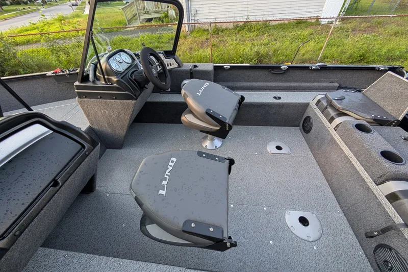 Slide: The Image of 2023 Lund 1650 Rebel XL Sport boat interior with seating and steering console. - 11