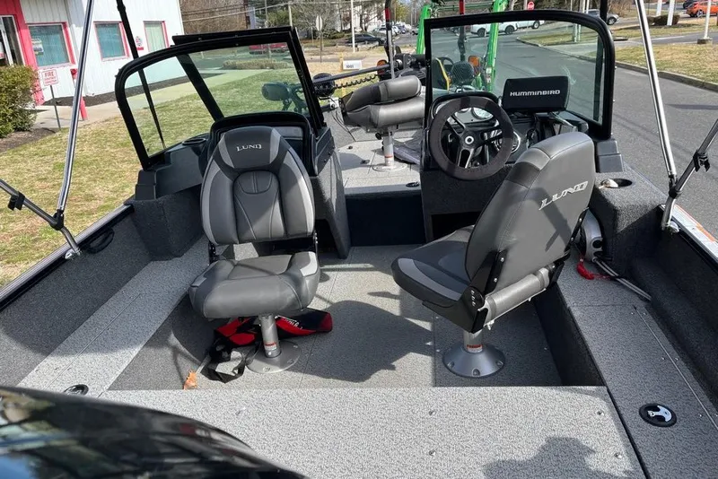 Slide: The Image of 2023 Lund 1650 Rebel XL Sport boat interior with seating and steering wheel. - 9