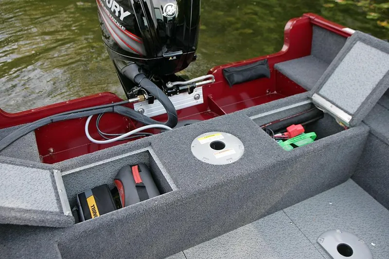 Slide: The Image of Manufacturer Provided Image: 2023 Lund 1650 Rebel XL Sport boat interior with storage compartments and Mercury outboard motor. - 23