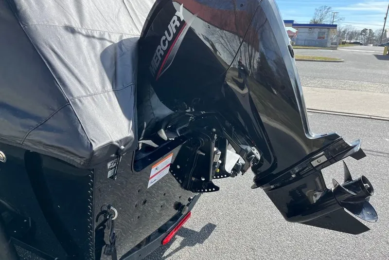 Slide: The Image of 2023 Lund 1650 Rebel XL Sport with Mercury outboard motor, parked on pavement. - 8