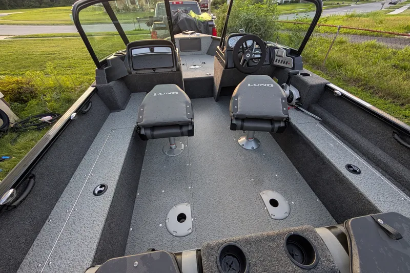 Slide: The Image of 2023 Lund 1650 Rebel XL Sport boat interior with seating and steering console. - 10