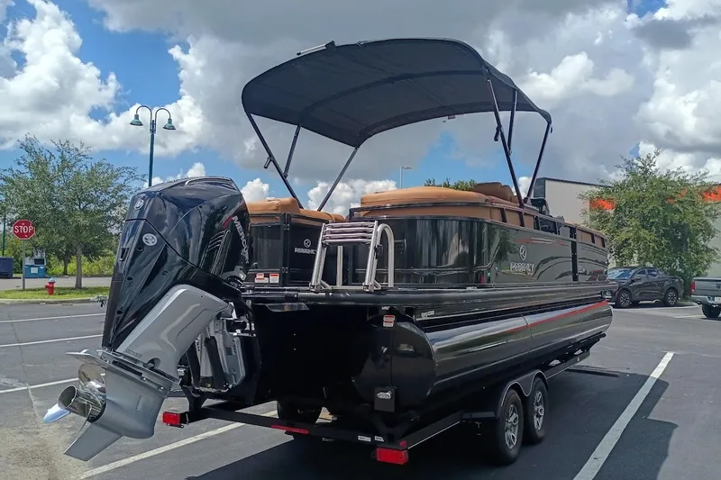 Slide: The Image of 2027 Regency 250 DL pontoon boat with canopy and powerful outboard motor. - 2
