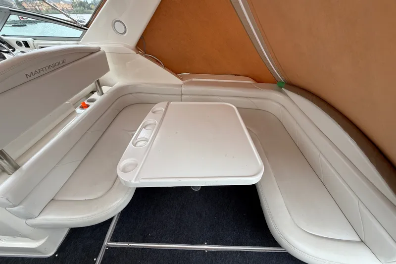 Slide: The Image of 1998 Wellcraft 3200 Martinique boat interior with white seating and table. - 11