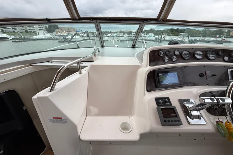 Slide: The Image of Cockpit view of 1998 Wellcraft 3200 Martinique boat with navigation instruments. - 32