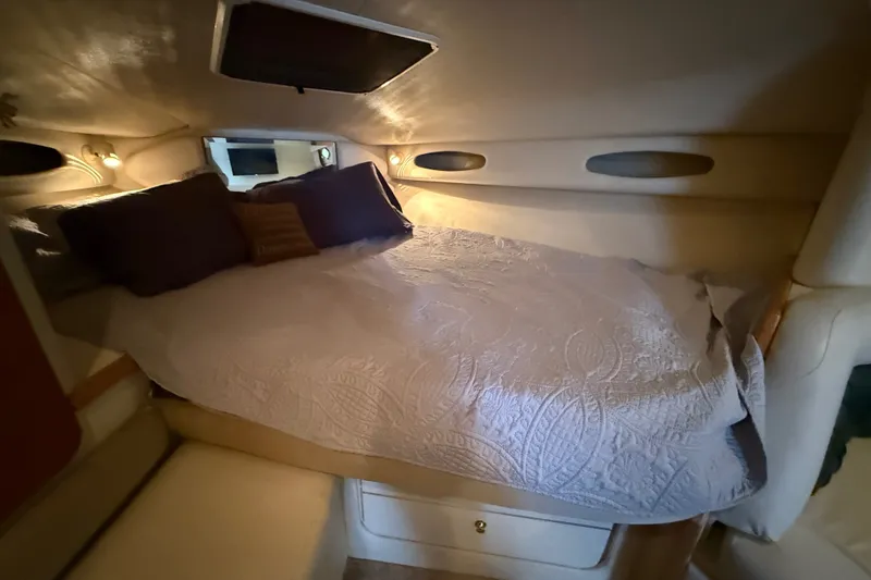 Slide: The Image of Cozy cabin interior of 1998 Wellcraft 3200 Martinique with bed and ambient lighting. - 49