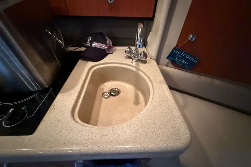 Slide: The Image of 1998 Wellcraft 3200 Martinique boat interior with sink and faucet. - 45