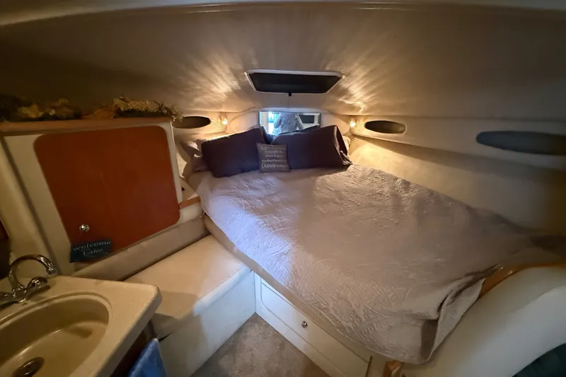 Slide: The Image of Cozy cabin interior of 1998 Wellcraft 3200 Martinique with bed and sink. - 48
