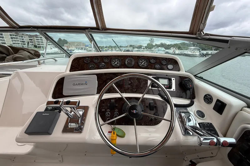 Slide: The Image of 1998 Wellcraft 3200 Martinique boat dashboard with Garmin navigation system and steering wheel. - 19