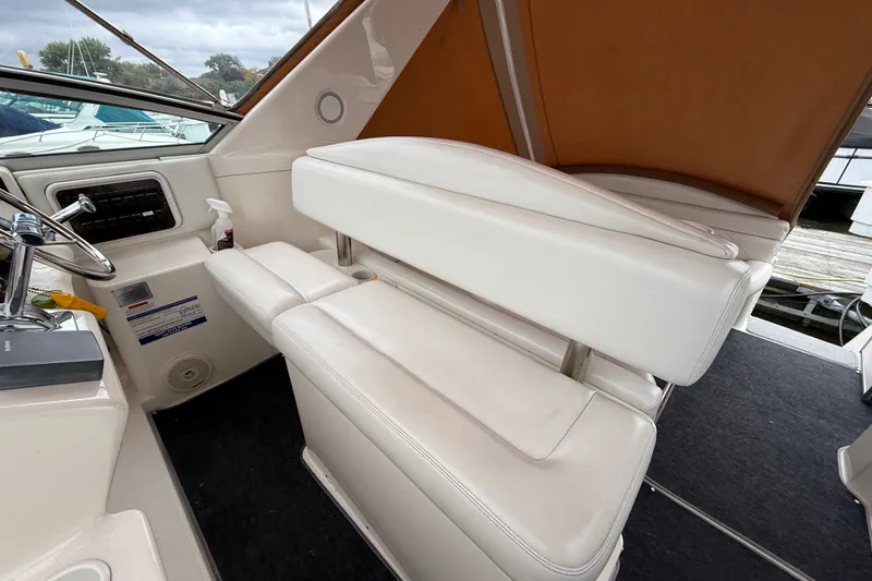 Slide: The Image of 1998 Wellcraft 3200 Martinique boat interior with white seating and steering wheel. - 18