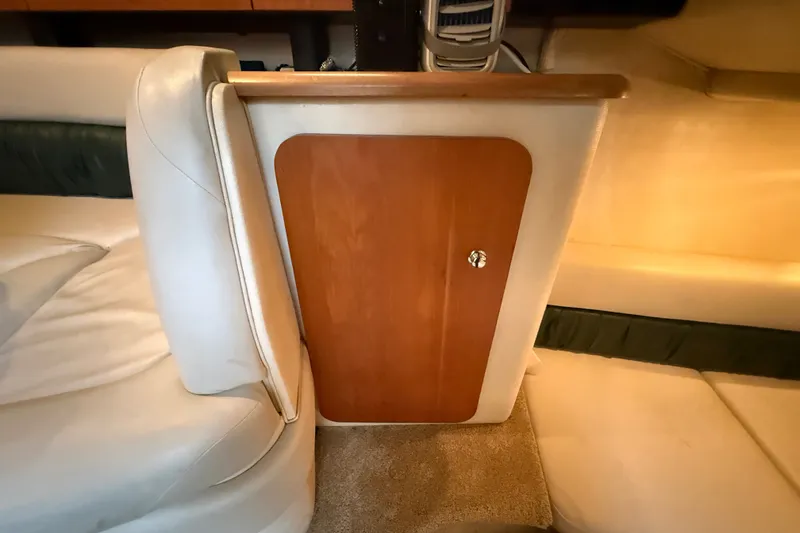 Slide: The Image of Interior of 1998 Wellcraft 3200 Martinique boat with wooden cabinet and cushioned seating. - 39