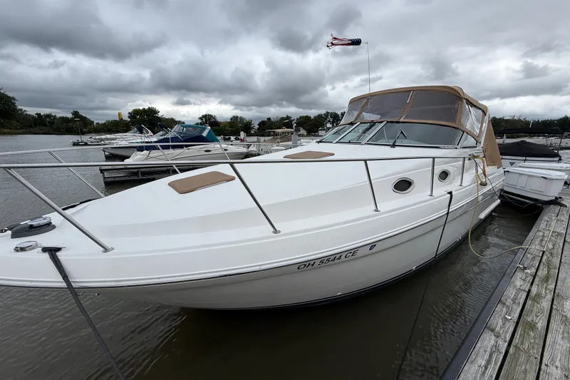 Slide: The Image of 1998 Wellcraft 3200 Martinique boat docked on a cloudy day. - 8