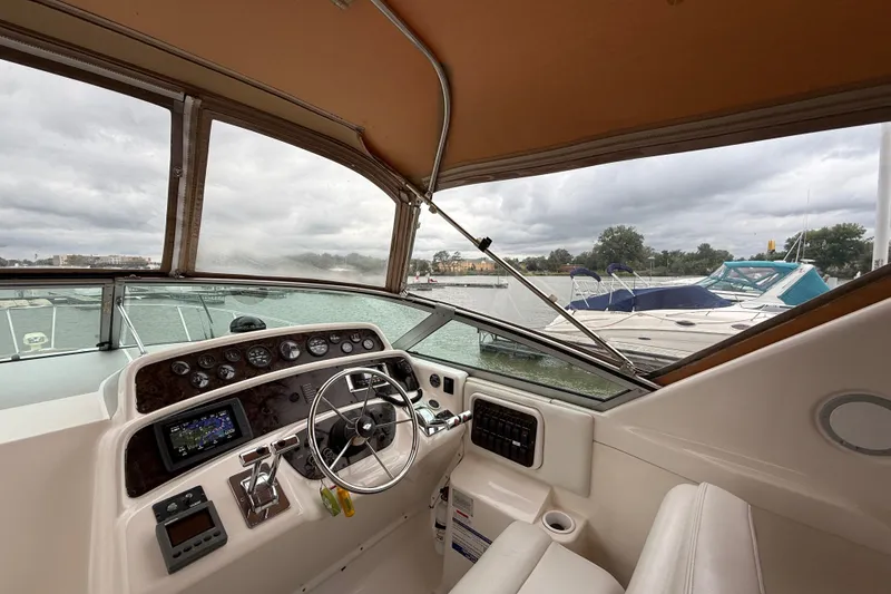 Slide: The Image of Interior view of 1998 Wellcraft 3200 Martinique boat cockpit with steering wheel and controls. - 29