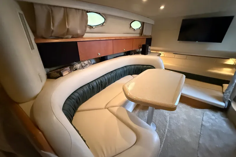 Slide: The Image of Interior of 1998 Wellcraft 3200 Martinique yacht with plush seating and table. - 53