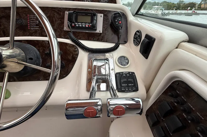 Slide: The Image of Control panel of a 1998 Wellcraft 3200 Martinique boat with steering wheel and throttle. - 21