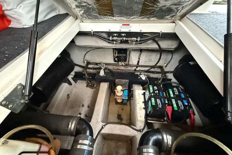 Slide: The Image of Engine compartment of a 1998 Wellcraft 3200 Martinique boat, showing batteries and mechanical components. - 59