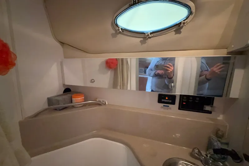 Slide: The Image of Interior of 1998 Wellcraft 3200 Martinique boat bathroom with mirror and sink. - 35