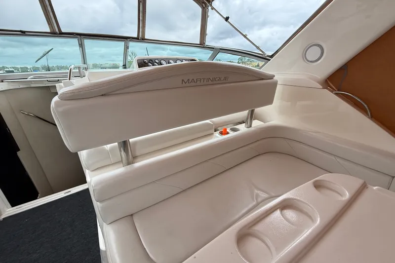 Slide: The Image of 1998 Wellcraft 3200 Martinique boat interior with white seating and helm view. - 12