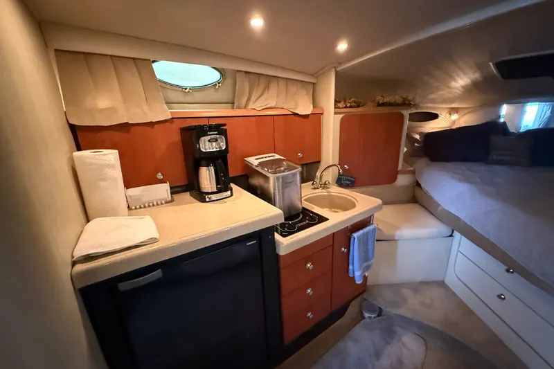 Slide: The Image of Interior of 1998 Wellcraft 3200 Martinique boat with kitchenette and cozy sleeping area. - 41
