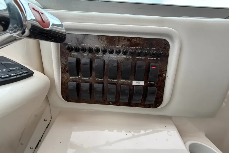 Slide: The Image of Control panel of a 1998 Wellcraft 3200 Martinique boat with labeled switches. - 22