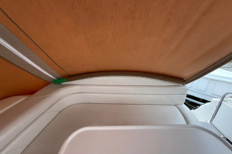 Slide: The Image of Interior view of a 1998 Wellcraft 3200 Martinique boat with cushioned seating. - 16