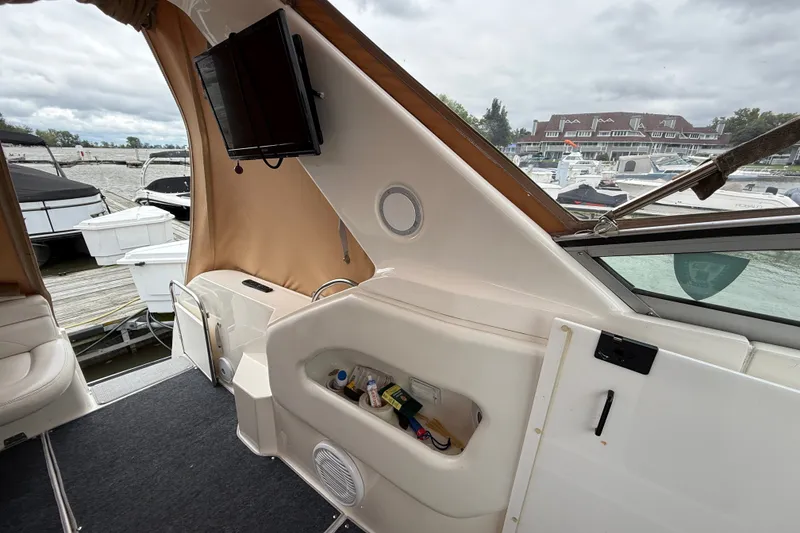 Slide: The Image of 1998 Wellcraft 3200 Martinique boat interior with dock view and storage compartment. - 14