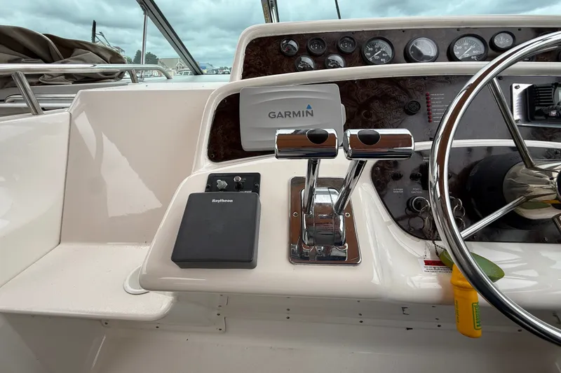 Slide: The Image of 1998 Wellcraft 3200 Martinique boat dashboard with Garmin and Raytheon equipment. - 20