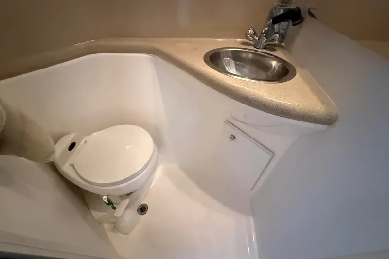 Slide: The Image of Compact bathroom in 1998 Wellcraft 3200 Martinique boat with toilet and sink. - 33