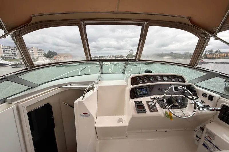 Slide: The Image of Cockpit view of 1998 Wellcraft 3200 Martinique boat with steering wheel and control panel. - 27