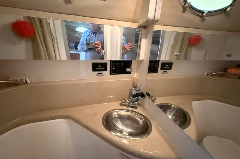 Slide: The Image of Interior of 1998 Wellcraft 3200 Martinique yacht bathroom with sink and mirror. - 34