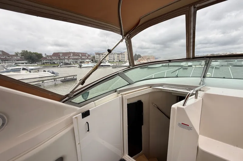 Slide: The Image of 1998 Wellcraft 3200 Martinique boat interior with marina view in the background. - 28