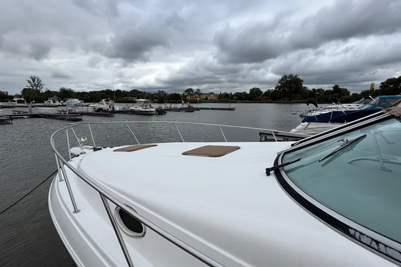 Slide: The Image of 1998 Wellcraft 3200 Martinique boat docked at a marina under cloudy skies. - 7