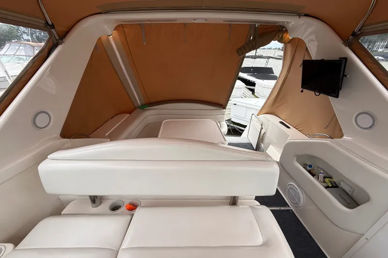 Slide: The Image of Interior of a 1998 Wellcraft 3200 Martinique boat with white seating and tan canopy. - 31