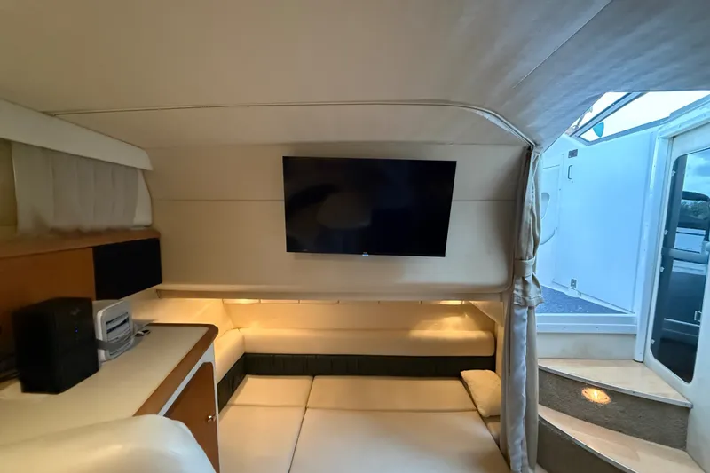 Slide: The Image of Interior of 1998 Wellcraft 3200 Martinique yacht with TV and cozy seating area. - 54