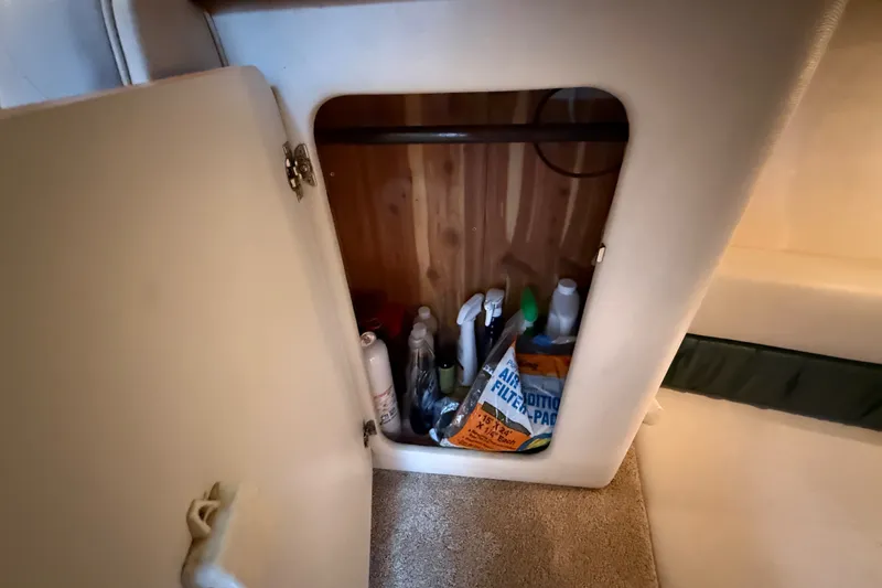 Slide: The Image of Storage compartment on a 1998 Wellcraft 3200 Martinique boat with cleaning supplies. - 40