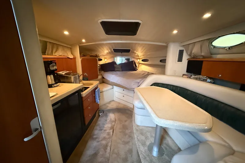 Slide: The Image of Interior of a 1998 Wellcraft 3200 Martinique boat with kitchenette and cozy sleeping area. - 37
