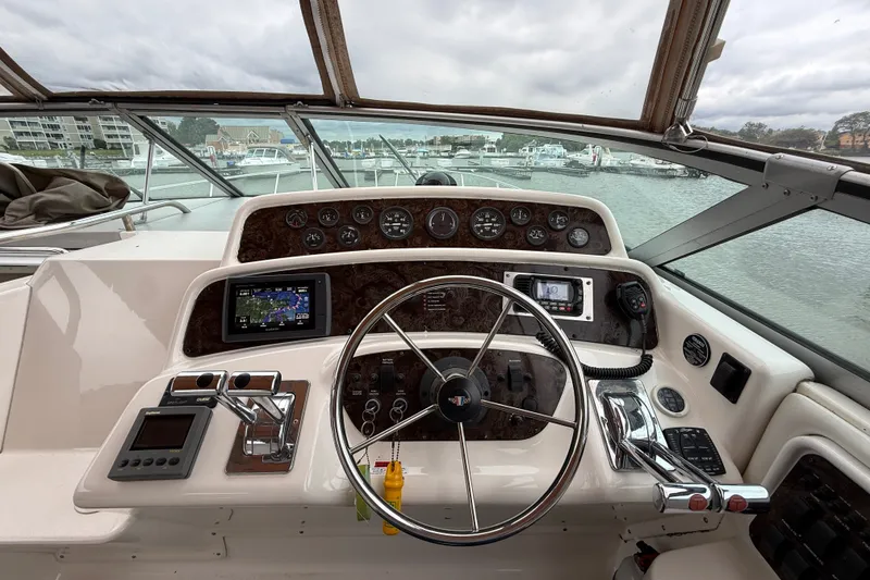 Slide: The Image of Cockpit view of a 1998 Wellcraft 3200 Martinique boat with steering wheel and navigation instruments. - 26