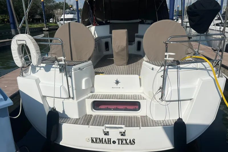 Slide: The Image of 2013 Jeanneau Sun Odyssey 44 DS docked, rear view with covered seating, Kemah, Texas. - 7