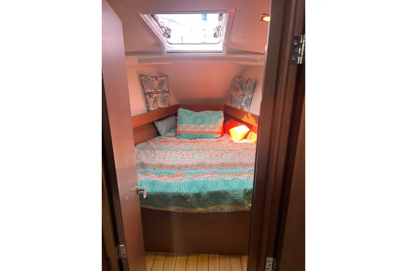 Slide: The Image of Cozy cabin interior of 2013 Jeanneau Sun Odyssey 44 DS with colorful bedding and skylight. - 22