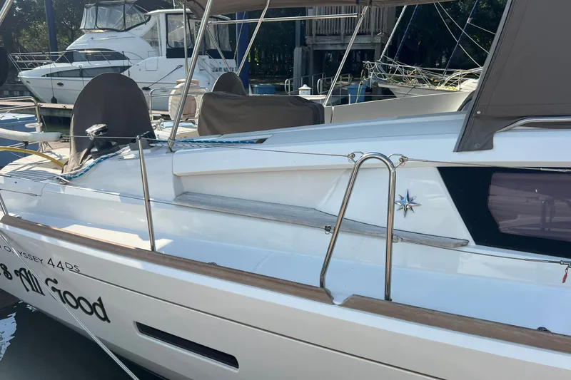 Slide: The Image of 2013 Jeanneau Sun Odyssey 44 DS sailboat docked, featuring sleek design and modern amenities. - 2