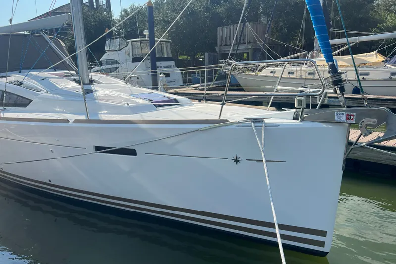 Slide: The Image of 2013 Jeanneau Sun Odyssey 44 DS sailboat docked at marina, showcasing sleek design and modern features. - 3