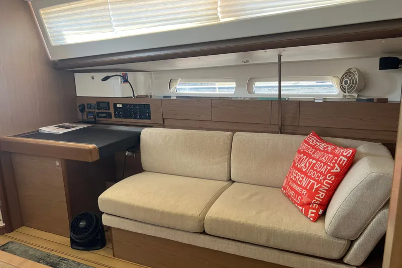 Slide: The Image of Interior of 2013 Jeanneau Sun Odyssey 44 DS with beige sofa and navigation station. - 13