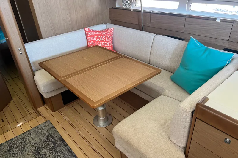 Slide: The Image of Interior of 2013 Jeanneau Sun Odyssey 44 DS with cozy seating and wooden table. - 17