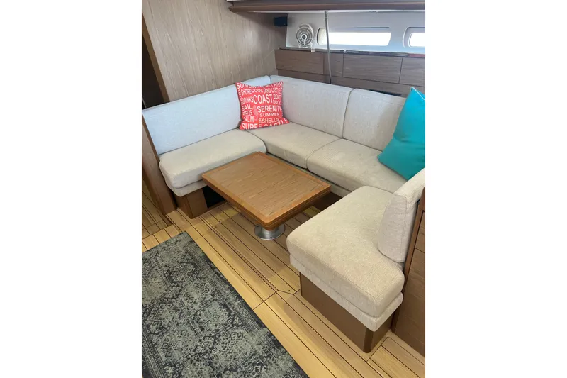 Slide: The Image of Cozy interior of 2013 Jeanneau Sun Odyssey 44 DS with beige seating and colorful cushions. - 15