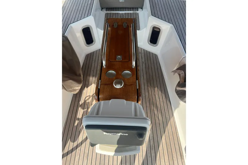 Slide: The Image of Cockpit of 2013 Jeanneau Sun Odyssey 44 DS with wooden table and seating. - 37