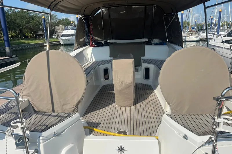 Slide: The Image of Cockpit of 2013 Jeanneau Sun Odyssey 44 DS sailboat with covered seating and helm. - 9