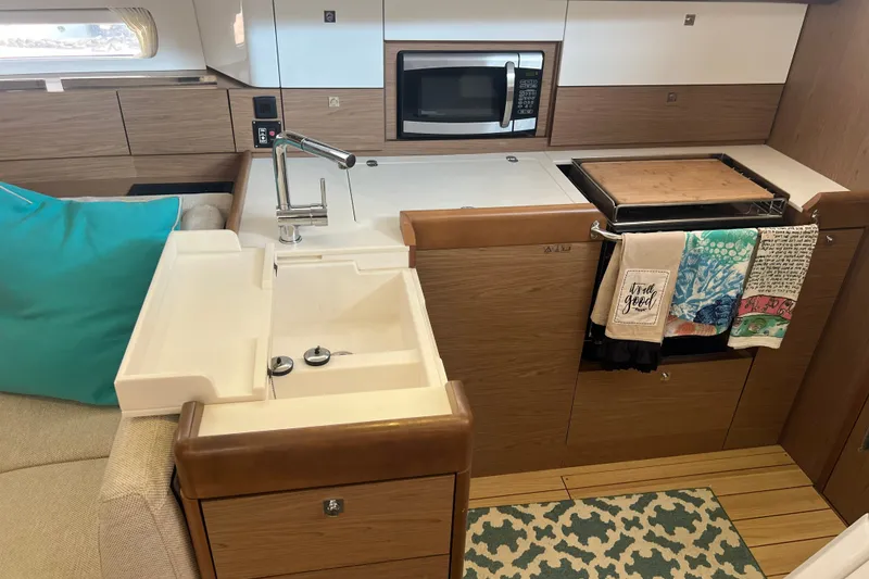 Slide: The Image of Interior of 2013 Jeanneau Sun Odyssey 44 DS yacht kitchen with sink, stove, and microwave. - 30